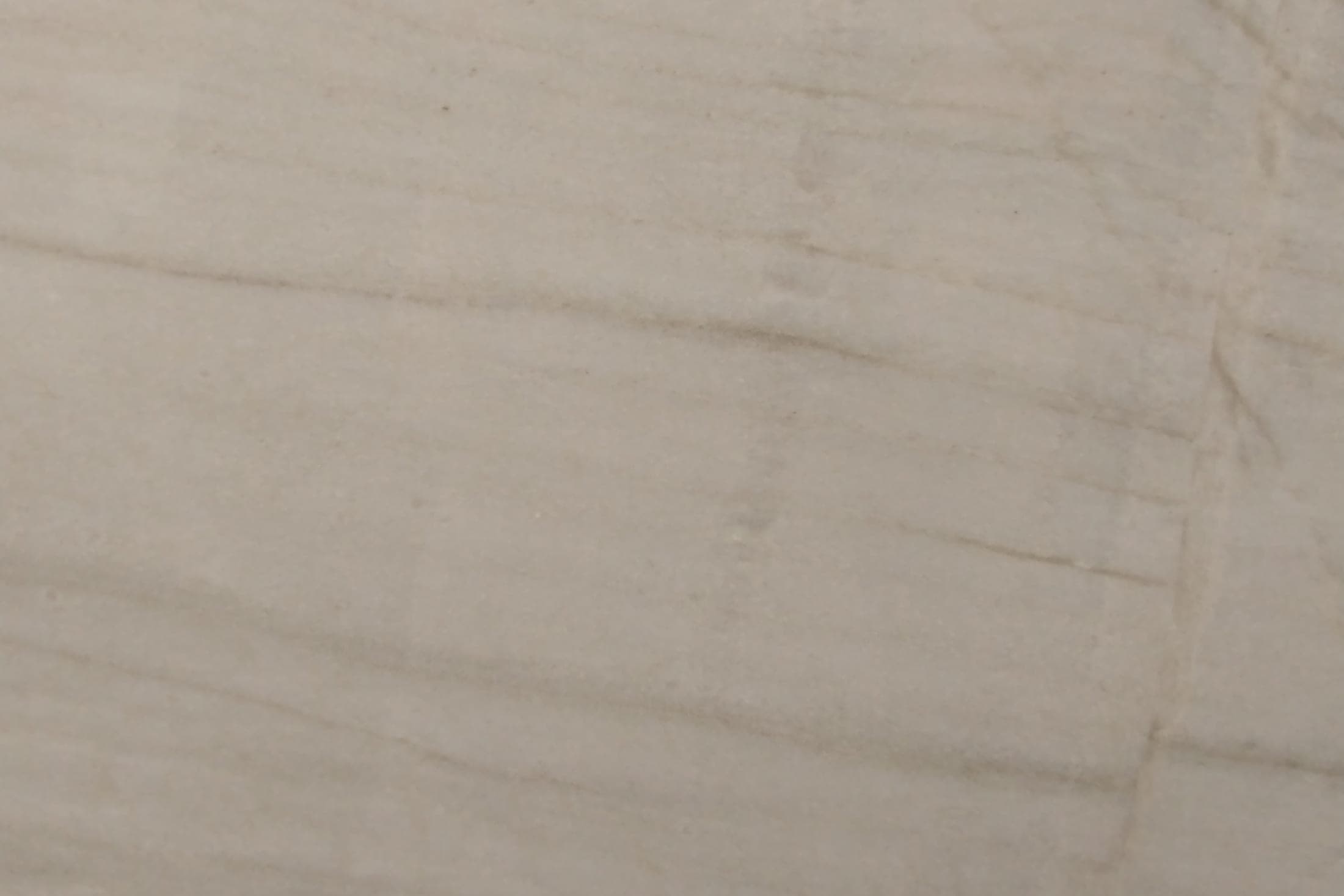 Close-up of a cream quartzite slab with soft taupe veining